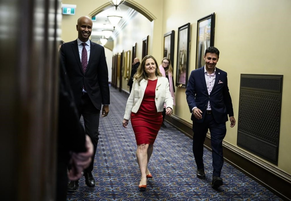 Liberal MP Chrystia Freeland, candidate for leader of the Liberal Party of Canada, makes her way a meeting of the Liberal caucus with Minister of International Development Ahmed Hussen, left, and Minister of Justice Arif Virani, right, in West Block on Parliament Hill in Ottawa, on Thursday, Jan. 23, 2025. THE CANADIAN PRESS/Justin Tang