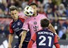 New England Revolution midfielder Nacho Gil (21) watches as Inter Miami midfielder David Ruiz, center, and Revolution forward Giacomo Vrioni, left, attempt control of the ball in the second half of an MLS soccer match, in Foxborough, Mass., Saturday, April 27, 2024. THE CANADIAN PRESS/AP-Mark Stockwell