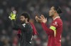 Liverpool's Virgil van Dijk and goalkeeper Alisson applaud at the end of the Champions League, opening phase soccer match between Liverpool and Lille at Anfield Stadium, in Liverpool, England, Tuesday, Jan.21, 2025. (AP Photo/Jon Super)