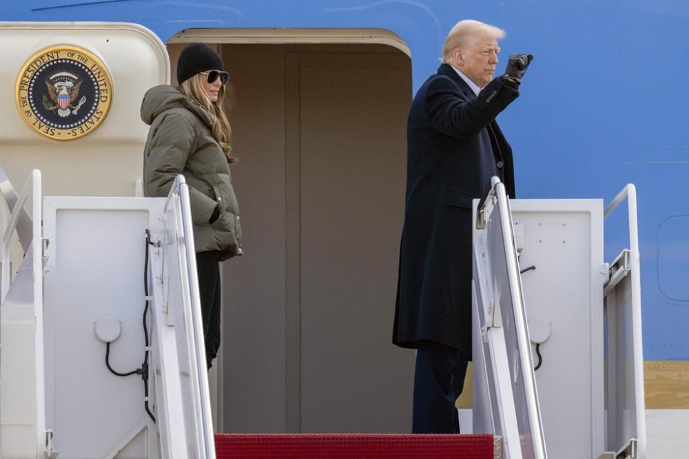 President Donald Trump and first lady Melania Trump wave as they board Air Force One at Joint Base Andrews, Md., Friday, Jan. 24, 2025, en route to Asheville, N.C. (AP Photo/Jess Rapfogel)