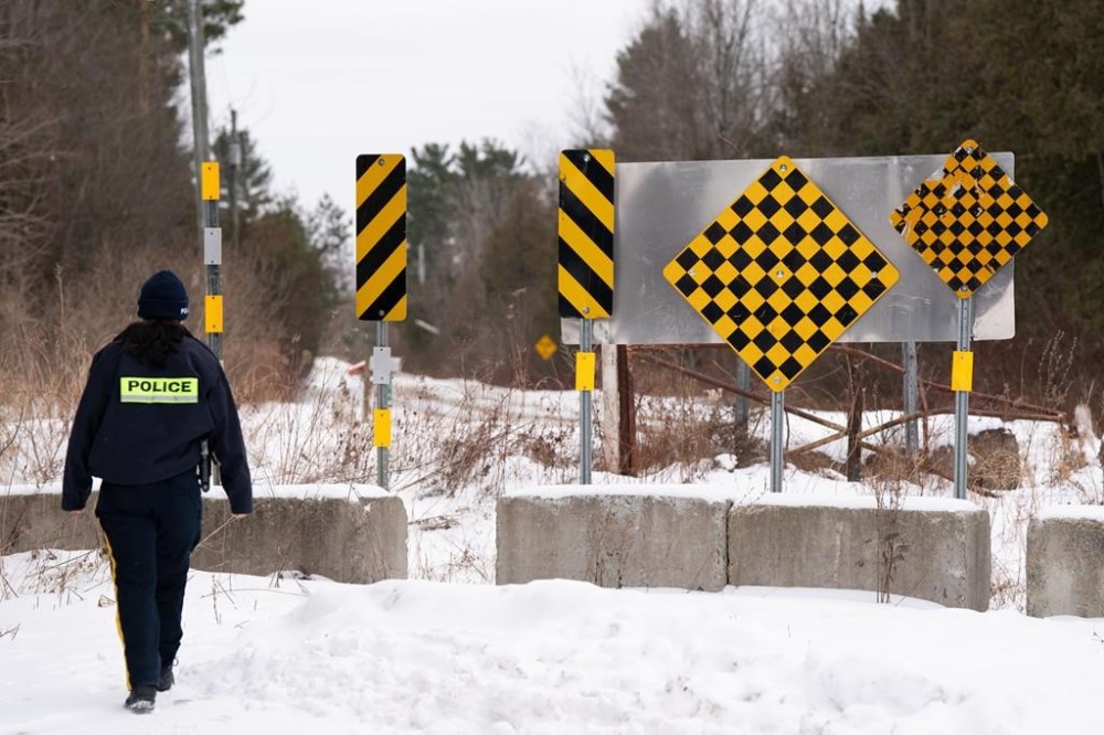The Canada Border Services Agency says it’s looking to open a processing centre for asylum seekers near the U.S. border in Quebec as a contingency plan in case of an “influx” of claimants. An RCMP officer checks the border between Quebec and New York State on Roxham Road in St. Bernard-de-Lacolle, Que. on Jan.15, 2025. THE CANADIAN PRESS/Christinne Muschi