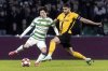 Celtic's Kyogo Furuhashi, left, of Japan, plays the ball as Young Boys' Loris Benito closes in during a Champions League soccer match between Scotland's Celtic Glasgow and Switzerland's BSC Young Boys at the Celtic Park Stadium in Glasgow, Scotland, Wednesday, Jan. 22, 2025. (Peter Klaunzer/Keystone via AP)