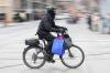 A food delivery courier rides an e-bike in Toronto on Wednesday. The federal government expects the country will need two to three times as much renewable energy capacity by 2050. (The Canadian Press)