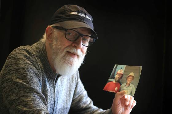 Paul Hiebert looks through photos of him with Jimmy Carter more than 40 years ago. (Ruth Bonneville / Free Press)