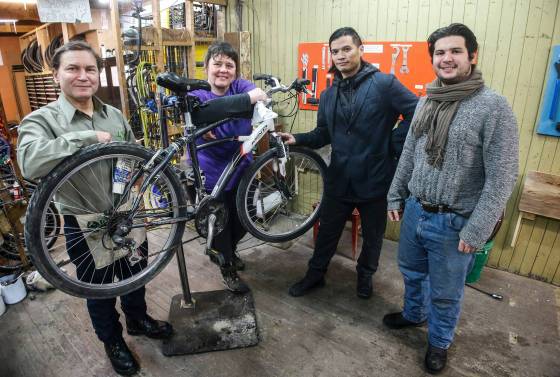 Bike Dump volunteers Chris Chypyha (from left), Sarah Furgale, Francis Liwanag and Jacques Gross in the workshop. (John Woods / Free Press)