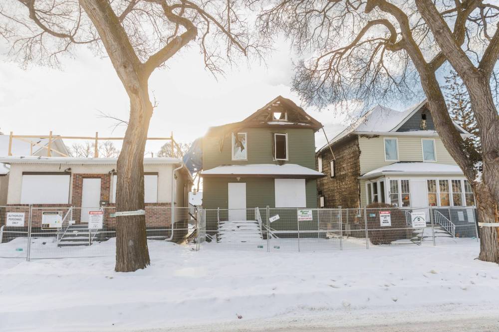 MIKE DEAL / FREE PRESS
The fire damaged homes at (from left) 72, 74, and 76 Cobourg Avenue. A Winnipeg man who lives next door to a the burned out, vacant homes now being targeted by squatters, says his concerns have been ignored by the city for months.