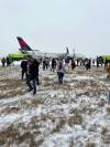 Jacob Markham photo
                                Passengers evacuate a Delta Airlines flight at Hartsfield-Jackson Atlanta International Airport Friday. The plane was carrying 201 passengers and seven crew members.