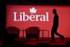 A stagehand works on the stage in between presenters at the 2023 Liberal National Convention in Ottawa, on Thursday, May 4, 2023. (Justin Tang / The Canadian Press)