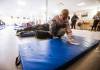 Fatima Sheriff, shelter host, cleans a bed for a guest at Oak Table/Just A Warm Sleep. (John Woods / Free Press)
