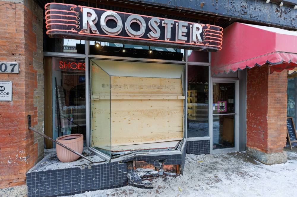 MIKE DEAL / FREE PRESS
The boarded-up window of Rooster Shoes at 105 Osborne St. Friday afternoon.