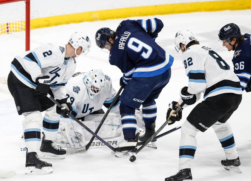 John Woods / THE CANADIAN PRESS
Utah Hockey Club goaltender Connor Ingram saves the shot from Winnipeg Jets’ Alex Iafallo as Olli Maatta and Kevin Stenlund defend during the first period.
