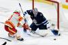 Fred Greenslade / The Canadian Press
                                Winnipeg Jets’ goaltender Eric Comrie makes one of his 20 saves against Calgary Flames’ Blake Coleman during NHL action in Winnipeg on Sunday.