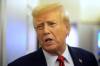 President Donald Trump speaks to reporters aboard Air Force One en route from Miami to Joint Base Andrews, Md., Monday, Jan. 27, 2025. (Mark Schiefelbein / The Associated Press)