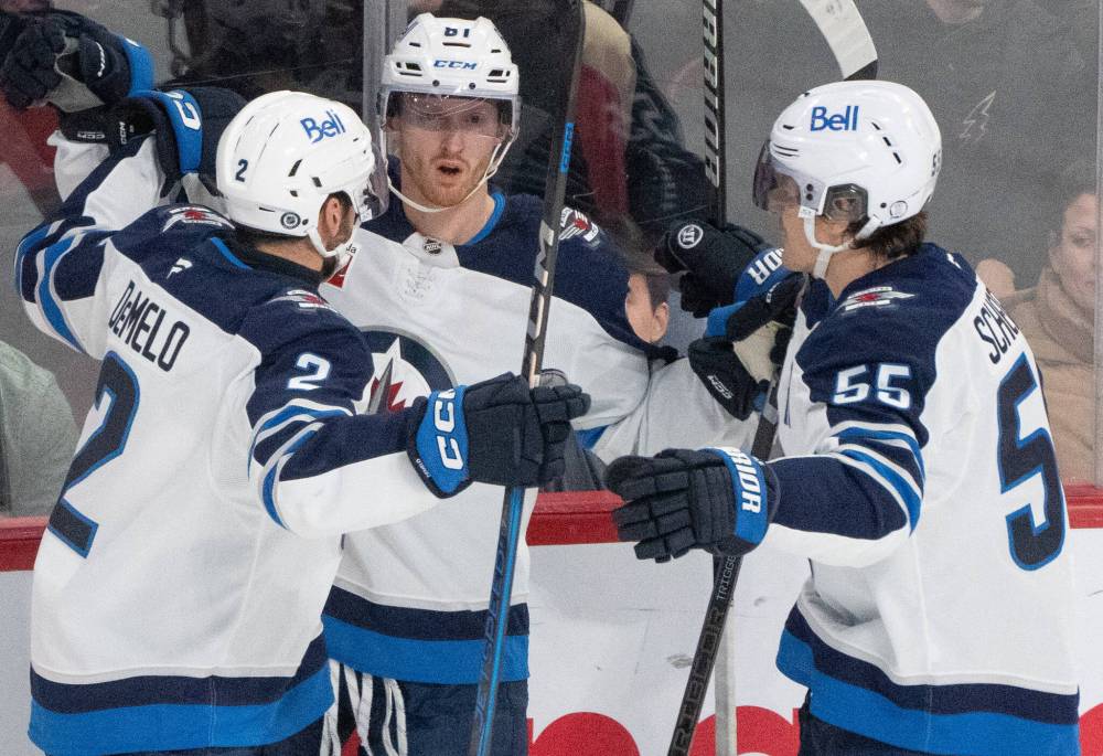 Christinne Muschi / THE CANADIAN PRESS
Winnipeg Jets’ Kyle Connor celebrates his goal against the Montreal Canadiens with teammates Dylan DeMelo and Mark Scheifele during the first period in Montreal on Tuesday.