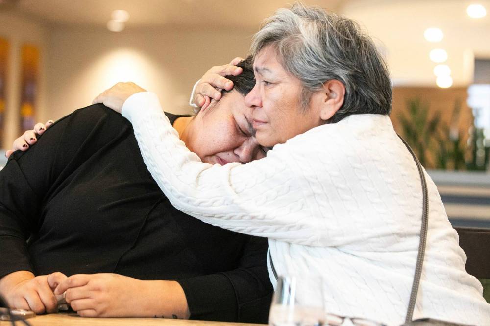MIKAELA MACKENZIE / FREE PRESS Jessiah’s aunt and primary caregiver Roberta Goosehead (left) and Goosehead’s mother Kimberly Scott embrace after speaking to the media about the death of two-year-old Jessiah Prestige Young on Thursday.