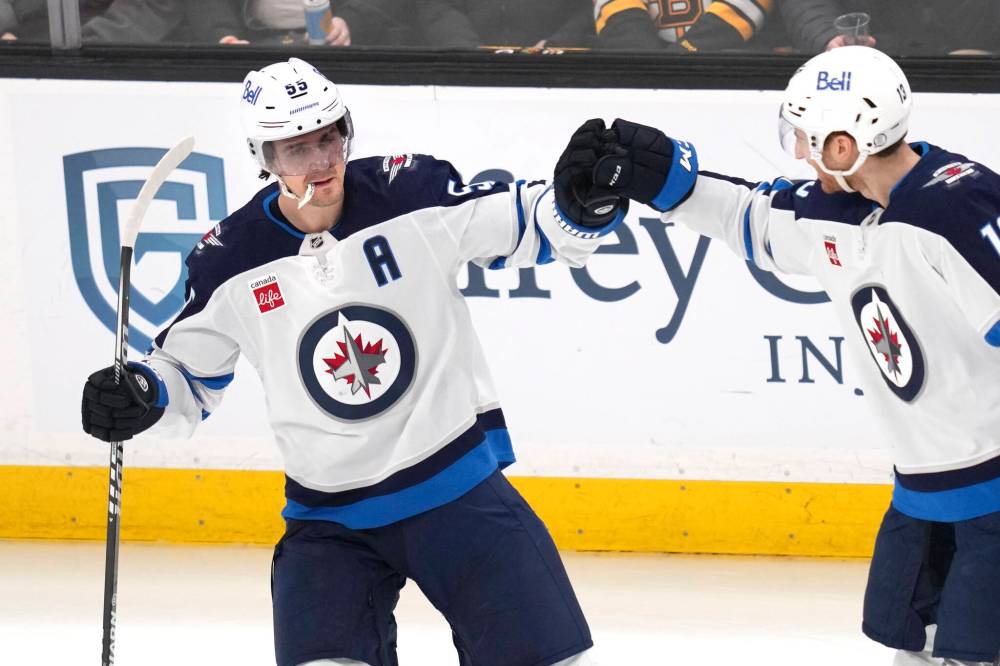 Charles Krupa / The Associated Press
Winnipeg Jets’ Mark Scheifele, left, is congratulated by Gabriel Vilardi after his second goal against the Bruins in the third period Thursday in Boston.