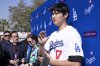 Los Angeles Dodgers' Shohei Ohtani talks to the media during a baseball interview during DodgerFest at Dodger Stadium, Saturday, Feb. 1, 2025, in Los Angeles. (AP Photo/Richard Vogel)