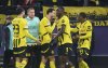Dortmund's Ramy Bensebaini, centre, celebrates after scoring his side's third goal during the Champions League opening phase soccer match between Borussia Dortmund and Shakhtar Donetsk in Dortmund, Germany, Jan. 29, 2025. (Bernd Thissen/dpa via AP)