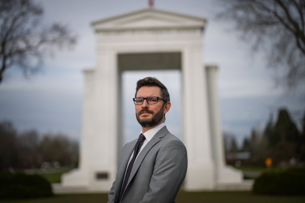 Lawyer Douglas Cowgill poses for a photograph at the Douglas-Peace Arch Canada-U. S. border crossing in Surrey, B.C., on Thursday, Jan. 23, 2025. For more than a decade, Cowgill, a Wisconsin native, has helped Americans in Canada navigate the complex task of renouncing their U.S. citizenship. THE CANADIAN PRESS/Darryl Dyck