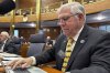 North Dakota Republican state Rep. Bill Tveit works at his desk on Wednesday, Jan. 22, 2025, in the House of Representatives at the state Capitol in Bismarck, N.D. (AP Photo/Jack Dura)