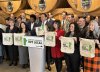 Manitoba Premier Wab Kinew and caucus members hold up tote bags during a press conference encouraging consumers to buy Manitoba goods and services, in Winnipeg, Wednesday, Feb. 5, 2025. THE CANADIAN PRESS/Steve Lambert