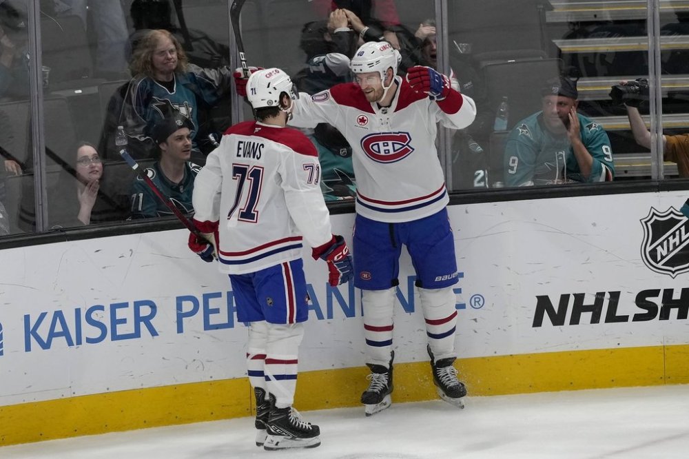 Montreal Canadiens right wing Joel Armia, middle right, is congratulated by center Jake Evans (71) after scoring a goal against the San Jose Sharks during the third period of an NHL hockey game in San Jose, Calif., Tuesday, Feb. 4, 2025. (AP Photo/Jeff Chiu)