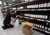 The four Atlantic premiers have paused their plans to respond to U.S. President Donald Trump's now postponed imposition of tariffs on Canadian goods and services. Liquor store employee Julie Spencer removes American products from the shelves of a Newfoundland Labrador Liquor Corporation (NLC) store in St John's on Monday, Feb.3, 2025. THE CANADIAN PRESS/Paul Daly