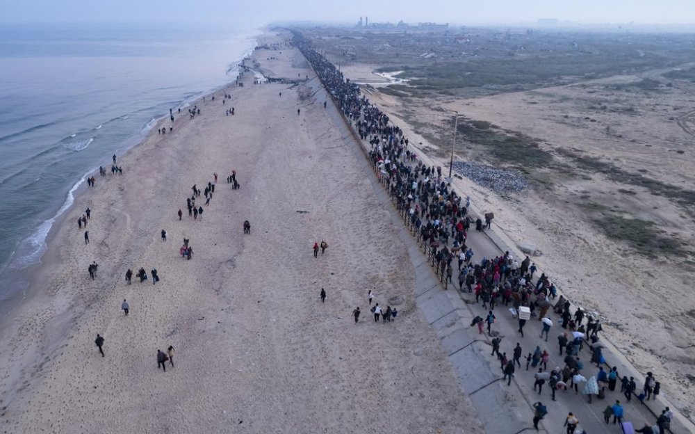 An aerial photograph taken by a drone shows displaced Palestinians return to their homes in the northern Gaza Strip, following Israel's decision to allow thousands of them to go back for the first time since the early weeks of the 15-month war with Hamas, Monday, Jan. 27, 2025. (AP Photo/ Mohammad Abu Samra)