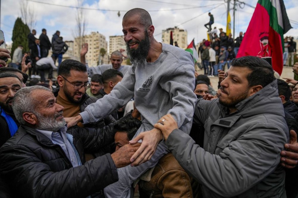 Palestinian prisoners are greeted by a crowd after being released from Israeli prison following a ceasefire agreement with Israel, in the West Bank city of Ramallah, Saturday, Jan. 25, 2025. (AP Photo/Nasser Nasser)