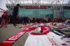 People lay flowers in memory of Denis Law prior the English Premier League soccer match between Manchester United and Brighton and Hove Albion, at the Old Trafford stadium in Manchester, England, Sunday, Jan. 19, 2025. (AP Photo/Dave Thompson)