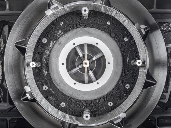 A top-down view of the OSIRIS-REx Touch-and-Go-Sample-Acquisition-Mechanism (TAGSAM) head with the lid removed, revealing the remainder of the asteroid sample inside. (NASA via The Associated Press)