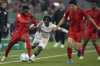 Leverkusen's Jeremie Frimpong, second left, is challenged by Bayern's Alphonso Davies, left, and Kim Min-jae, right, during a German Cup round of 16 soccer match at the Allianz Arena in Munich, Germany, Monday. Dec. 3, 2024. Davies has re-signed with Bayern Munich, ending a lengthy romance with other big-name clubs reportedly interested in the Canada captain. THE CANADIAN PRESS/AP/Matthias Schrader