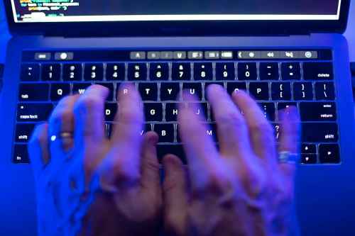 An October cyberattack on Canada's largest public library system that brought down its website and exposed sensitive employee information will keep some services offline into 2024. A man uses a computer keyboard in Toronto, Monday, Oct. 9, 2023 in this photo illustration. THE CANADIAN PRESS/Graeme Roy
