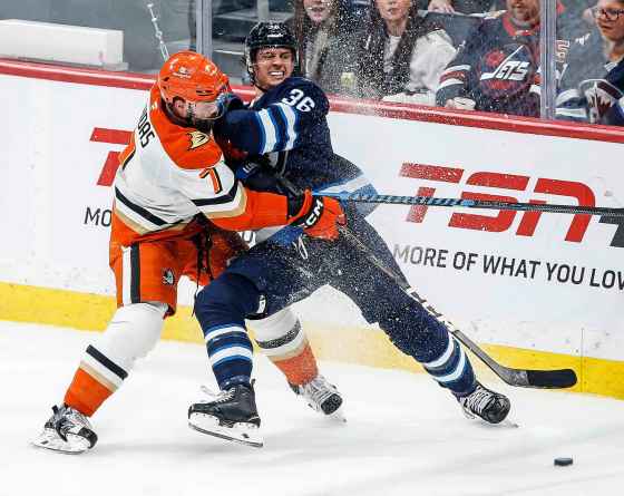 Winnipeg Jets' Morgan Barron (36) and Anaheim Ducks' Radko Gudas (7) jostle for a loose puck during second period NHL action Thursday. (John Woods / The Canadian Press)
