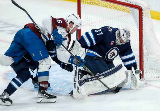 Winnipeg Jets goaltender Connor Hellebuyck (37) saves the shot from Colorado Avalanche's Mikko Rantanen (96) as Jets' Dylan DeMelo (2) defends during the Jan. 11 game. The two teams are having their fourth and final meeting of the season tonight. (John Woods / Canadian Press files)