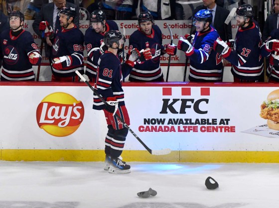 Kyle Connor celebrates his third goal of the game against the Vancouver Canucks with his teammates Tuesday night in Winnipeg. (Fred Greenslade / The Canadian Press)