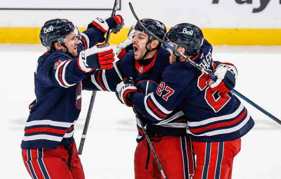 Winnipeg Jets' Neal Pionk (4), Dylan DeMelo (2) and Nikolaj Ehlers (27) celebrate DeMelo's game winning goal against the Seattle Kraken during the closing seconds of third period NHL action in Winnipeg Thursday. (John Woods / The Canadian Press)