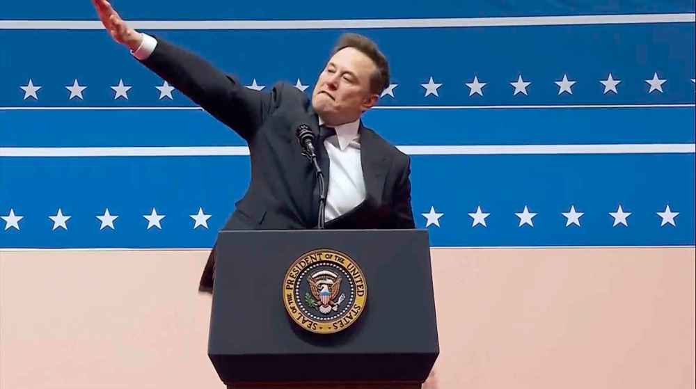 Elon Musk gestures while speaking at an indoor Presidential Inauguration parade event in Washington, Monday, Jan. 20, 2025. (AP Photo)