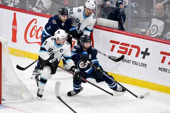 Utah Hockey Club's Clayton Keller (9) and Winnipeg Jets' Josh Morrissey (44) battle for the puck during their last match-up in Winnipeg Nov. 5.  The Jets won that game 3-0. (Fred Greenslade / Canadian Press files)