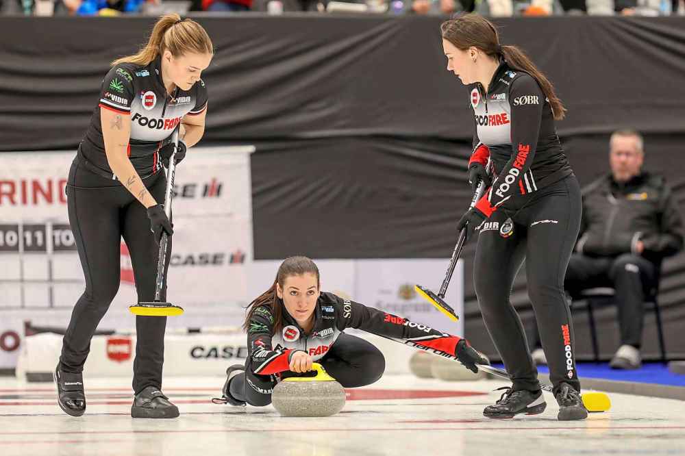 Skip Beth Peterson (centre) releases her rock as Meghan Walter (left) and Melissa Gordon-Kurz (right) during the championship game. (Connie Laliberte photo)
