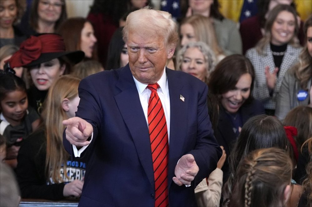 President Donald Trump gestures after signing an executive order barring transgender female athletes from competing in women's or girls' sporting events, in the East Room of the White House, Wednesday, Feb. 5, 2025, in Washington. (AP Photo/Alex Brandon)