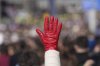 A woman raises a red glove symbolizing blood during a student-led 24 hour block on an intersection to protest the deaths of 15 people killed in the November collapse of a train station canopy, in Belgrade, Serbia, Monday, Jan. 27, 2025. (AP Photo/Darko Vojinovic)