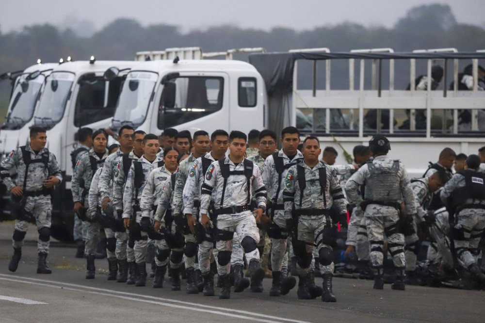 Mexican National Guards prepare to board an aircraft at the International Airport in Merida, Mexico, Tuesday, Feb. 4, 2025, to travel north to reinforce the country's border with the United States. (AP Photo/Martin Zetina)