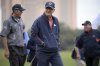 FILE - Matt Kuchar, left, and his father, Peter Kuchar, center, leave the second green after making their putt during the first round of the Father Son Challenge golf tournament Saturday, Dec. 15, 2018, in Orlando, Fla. (AP Photo/Phelan M. Ebenhack, File)