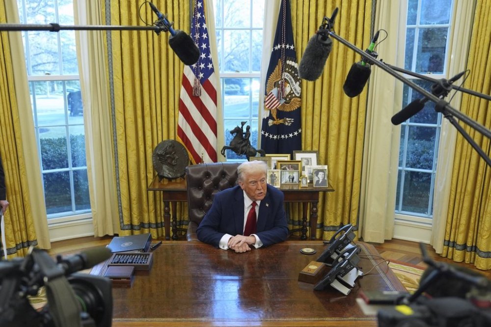 President Donald Trump talks with reporters as he signs executive orders in the Oval Office at the White House, Thursday, Jan. 30, 2025, in Washington. THE CANADIAN PRESS/AP/Evan Vucci