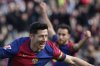 Barcelona's Robert Lewandowski, left, celebrates after scoring the opening goal during a Spanish La Liga soccer match between Barcelona and Alaves at the Lluis Companys Olympic Stadium in Barcelona, Spain, Sunday Feb. 2, 2025. (AP Photo/Joan Monfort)