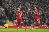 Liverpool's Mohamed Salah, left, celebrates with Dominik Szoboszlai after scoring the second goal from the penalty spot during the English League Cup semifinal second leg soccer match between Liverpool and Tottenham Hotspur at Anfield Stadium in Liverpool, England, Thursday, Feb. 6, 2025. (AP Photo/Jon Super)