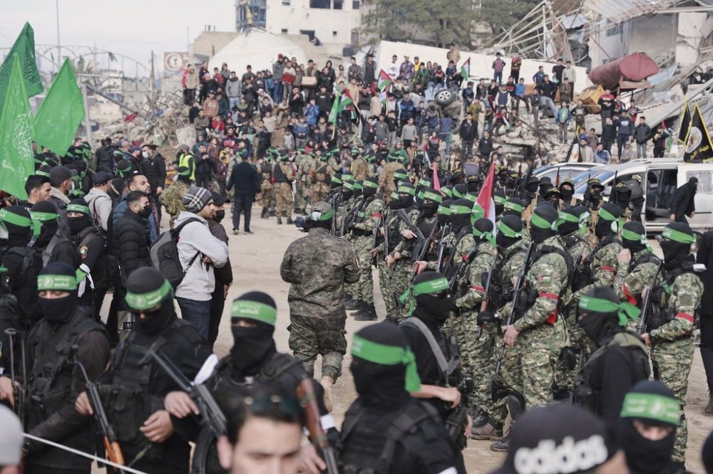 Hamas and Islamic Jihad fighters are deployed in central Gaza City ahead of the planned release of four Israeli female hostages set to be handed over to the Red Cross in Gaza City on Saturday, Jan. 25, 2025. (AP Photo/Abed Hajjar)