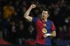 Barcelona's Robert Lewandowski celebrates after scoring his side's sixth goal during the Spanish La Liga soccer match between Barcelona and Valencia at the Lluis Companys Olympic Stadium in Barcelona, Spain, Sunday, Jan. 26, 2025. (AP Photo/Joan Monfort)