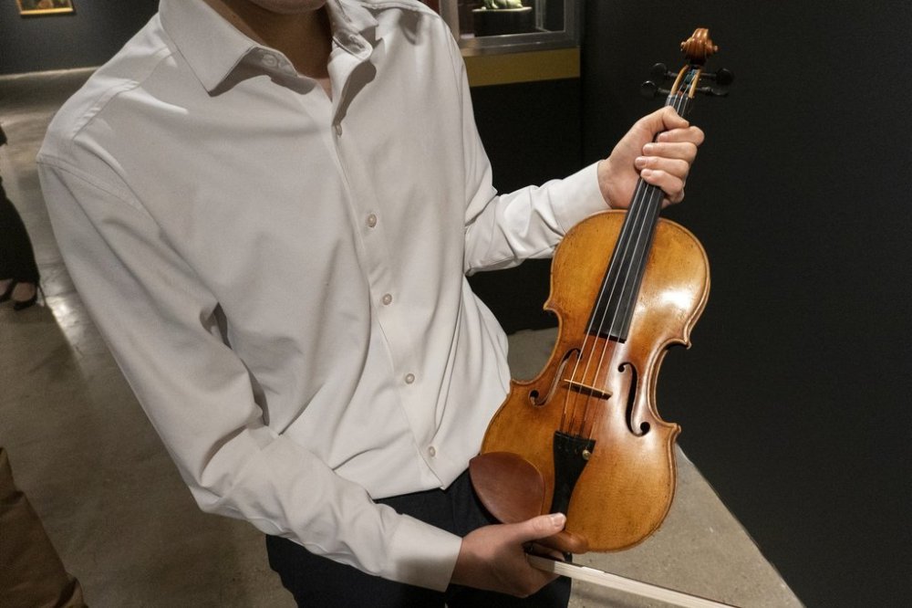 Violinist Stefan Jackiw holds the 1714 Joachim-Ma Stradivarius at Sotheby's auction house in New York on Monday, Feb. 3, 2025. (AP Photo/Ted Shaffrey)